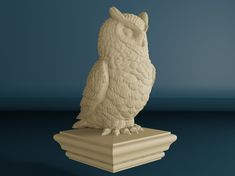 an owl statue sitting on top of a white pedestal