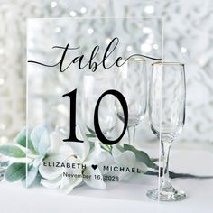 a table number with two wine glasses next to each other