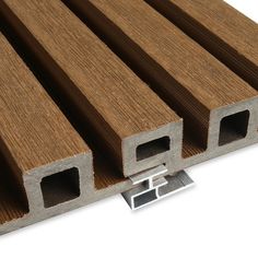 a close up view of some wood planks on a white surface with metal brackets