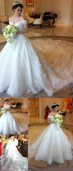 a woman in a white wedding dress holding a bouquet and looking down at the floor