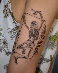 a woman with a skeleton tattoo on her arm