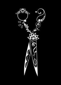 a pair of scissors with floral designs on the handles are shown against a black background