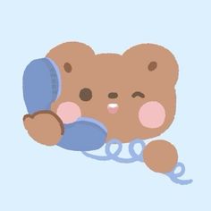 a brown teddy bear laying on top of a blue pillow with a pink ear tag