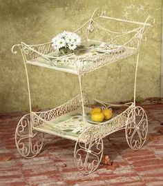 a painting of a white baby carriage with lemons on the front and side wheels