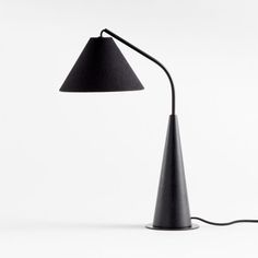 a black lamp on a white background with a cord attached to the base and one light turned on