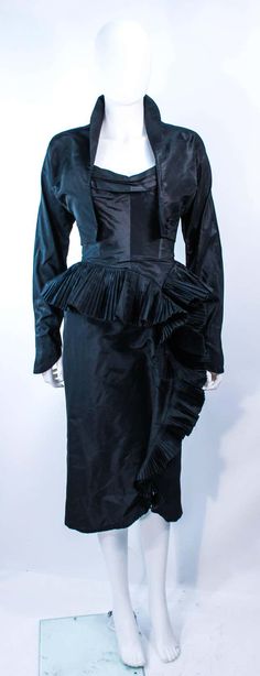 For Sale on 1stDibs - This Irene ensemble is composed of black silk. The strapless cocktail dress features a pleated bust with side draped, cascading ruffle, with interior boning. 1950s Clothes, Strapless Cocktail Dress, 1950s Outfits, Cocktail Gowns, Black Silk, Timeless Fashion, Ruffles, Victorian Dress, Evening Dresses