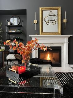 a living room filled with furniture and a fire place next to a wall mounted fireplace