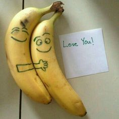 two bananas with faces drawn on them next to a note that says i love you