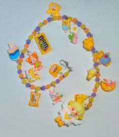 a bunch of toys that are sitting on a table together in the shape of necklaces