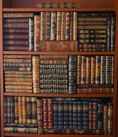 a book shelf filled with lots of books on top of wooden shelves next to each other