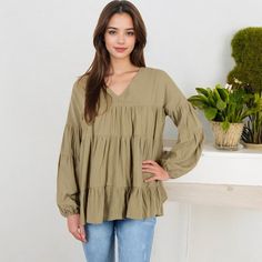 Embrace effortless style with the Anna-Kaci Women's V-Neck Tiered Babydoll Top. This top features a flattering V-neckline and a relaxed, tiered babydoll silhouette that adds a touch of bohemian flair to your look. The long puff sleeves with elastic cuffs provide a romantic touch, making this top perfect for both casual days and dressier occasions. Pair it with your favorite jeans or leggings for a chic, comfortable outfit that stands out in any setting. Casual Billowy V-neck Tops, Spring V-neck Peasant Top With Relaxed Fit, Spring V-neck Relaxed Fit Peasant Top, Casual V-neck Peasant Top For Spring, Casual V-neck Peasant Top For Fall, Spring V-neck Peasant Top For Brunch, Chic V-neck Cotton Peasant Top, Cotton V-neck Peasant Top For Fall, Fall V-neck Peasant Top With Ruffles