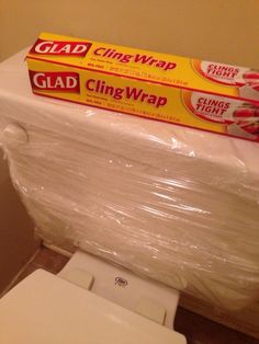 a stack of cling wrap sitting on top of a toilet