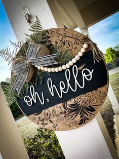 a welcome sign hanging on the side of a house