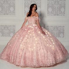 The fairy tale quinceanera ball gown features stunning three-dimensional floral appliques and a semi-sweetheart neckline with feather detailing. This beautiful dress also includes a small matching cape. Pink And Gold Quinceanera Dress, Quinceanera Dresses Damas, Fabric Beading, Quinceañera Dresses, Damas Dresses, Pink Quince, Quinceanera Dresses Pink, Big Dresses, Pretty Quinceanera Dresses