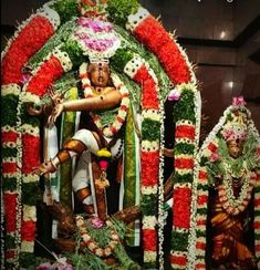 an idol is displayed with flowers and garlands