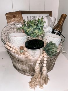 a basket filled with lots of different items on top of a white counter next to a bottle of wine