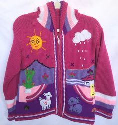 Landscape Arpillera Hooded Jacket for kidsThis lovely arpillera jacket has been handmade with love by creative artisans in Lima, Peru.The jacket is embroidered with cotton.Arpillera is a patchwork that represents different landscapes and tell stories in a happy way.Size: 8 up to 6 years oldColor: MagentaMaterial: 25% wool sheep and 75% acrylic<p>Washable/ hang dry</p><br/><p>Sleeves: 13" long</p><br/><p>Shoulder to bottom: 15.5"long</p><br/>& Fun Pink Winter Outerwear, Fun Pink Outerwear For Winter, Cute Handmade Outerwear For Fall, Casual Handmade Pink Outerwear, Handmade Pink Winter Outerwear, Wool Sheep, Jacket Zipper, Lima Peru, Long Sleeve Jacket