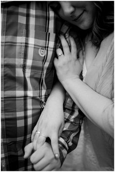 a man and woman embracing each other in black and white