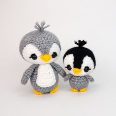 two small crocheted stuffed animals sitting next to each other