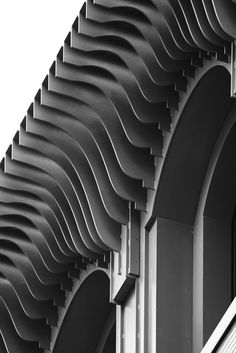 black and white photograph of an architectural structure with wavy lines on the side of it