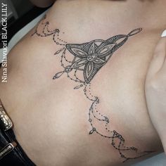 a woman's stomach with a tattoo on the side and an arrow in the middle