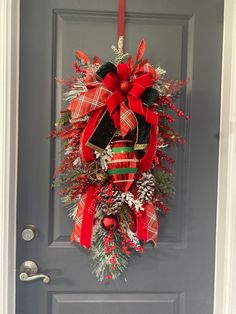 a christmas wreath hanging on the front door