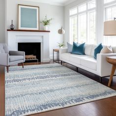 a living room filled with furniture and a fire place next to a white couch in front of a fireplace