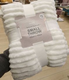 a pile of white fluffy pillows in a store