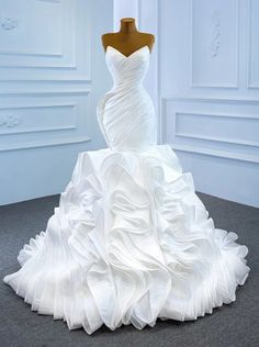 a white wedding dress on a mannequin