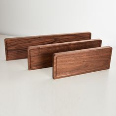 three pieces of wood sitting next to each other