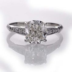 an engagement ring with a cushion cut diamond