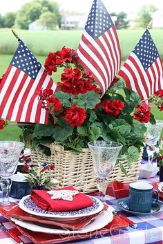 an outdoor table set with red, white and blue place settings for fourth of july