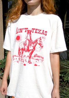 This ain't Texas (woo!) An ode to Queen Bey, featuring hand drawn graphics and and a worn-in western print. Design is printed on a unisex garment-dyed t-shirt in Ivory. 100% ring-spun cotton Model wears size Small. Vintage Summer T-shirt For Rodeo, Graphic Print Crew Neck T-shirt For Rodeo, Western Style Relaxed Fit Graphic T-shirt, Western Style Relaxed Fit T-shirt With Graphic Print, White Screen Print T-shirt For Rodeo, Western Style Crew Neck T-shirt With Graphic Print, Short Sleeve Graphic T-shirt For Rodeo, Short Sleeve Graphic Print T-shirt For Rodeo, Graphic Print Short Sleeve T-shirt For Rodeo