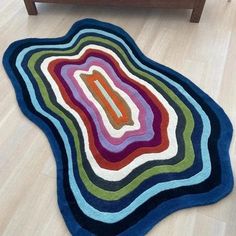 a multicolored rug on the floor in a living room