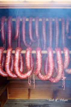 several sausages are being cooked on the grill