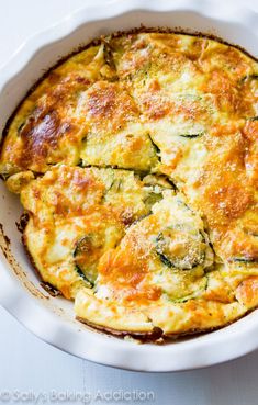 a casserole dish with spinach and cheese in it on a white plate