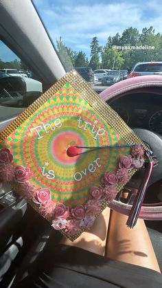 a graduation cap with the words, the city is over written on it sitting in a car