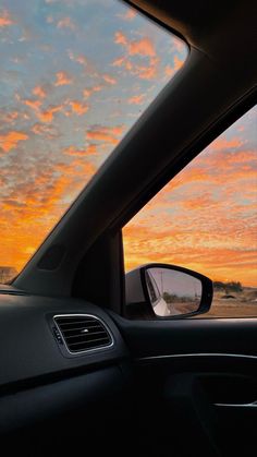 the sun is setting in the distance as seen from inside a car