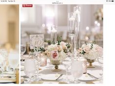 the centerpieces on this table are filled with pink and white flowers