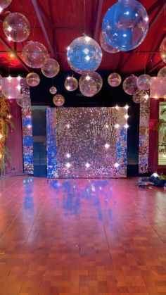 an empty dance floor with disco balls hanging from the ceiling