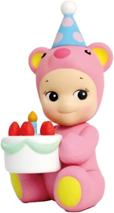 a small toy bear with a birthday cake