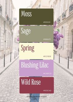 a person standing in the middle of a street holding a sign that says moss sage spring bluering lilac wild rose