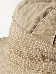 An ode to Ernest Hemingway's novella of the same name, KAPITAL's 'The Old Man and the Sea' bucket hat is purposely distressed to look aged and weather-beaten. Made locally in Japan, it's cut from cotton-twill and embroidered with intricate contrast topstitching. A buckled tab across the crown is a cool feature that also helps with the shape. Beige Canvas Hat With Short Brim, Beige Canvas Bucket Hat, Beige Wide Brim Canvas Hat, Beige Canvas Hats For Spring, Beige Canvas Spring Hats, Spring Beige Canvas Hats, Vintage Cotton Bucket Hat With Flat Brim, Vintage Beige Bucket Hat With Curved Brim, Vintage Beige Cotton Hat