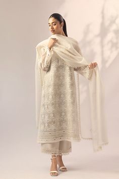 This aari embroidered ivory organza kurta with appliqué and lacework paired with rawsilk culottes is perfect for a daytime elegant look. A matching organza dupatta with embroidery and lace edging enhances the beauty of this ensemble. Elegant Off White Sets With Intricate Embroidery, Elegant Off-white Sets With Intricate Embroidery, Elegant Cotton Silk Palazzo Set With Chikankari Embroidery, Off White Palazzo Set With Intricate Embroidery For Eid, Cream Organza Sets With Intricate Embroidery, Elegant Embroidered Off White Anarkali Set, Elegant Embroidered Chanderi Palazzo Set, Elegant Cotton Silk Palazzo Set For Eid, Elegant Off White Anarkali Set With Intricate Embroidery