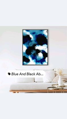 a living room with a couch, coffee table and painting on the wall that says blue and black ab