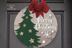 a wooden christmas ornament hanging on a door with a red bow and snowflakes