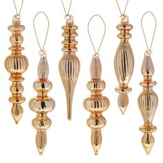 four glass ornaments hanging from strings in different shapes and sizes, each with a gold colored finish