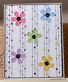 a card with flowers and beads on it