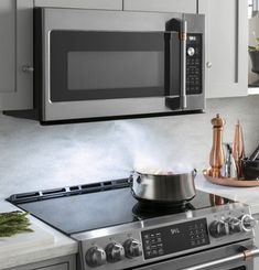 a stove top oven sitting inside of a kitchen