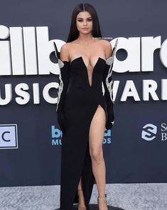 an image of a woman in a black and white dress with high slits on the red carpet